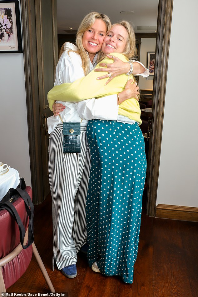 Cressida wore a dark green and white silk jumpsuit featuring a polka dot design and a bright yellow cropped jumper