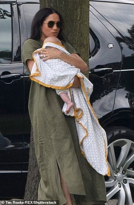 Meghan is pictured with Prince Archie in July 2019