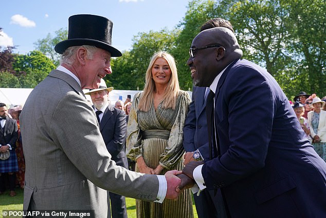 Charles is pictured shaking hands with Enninful during The Sovereign's Creative Industries Garden Party at Buckingham Palace, on May 15, 2024