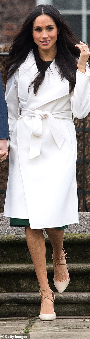 Meghan wears a white belted coat by Canadian brand Line the Label at Kensington Palace in 2017