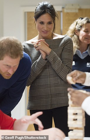 Meghan watches a game of Jenga in Cardiff in January 2018