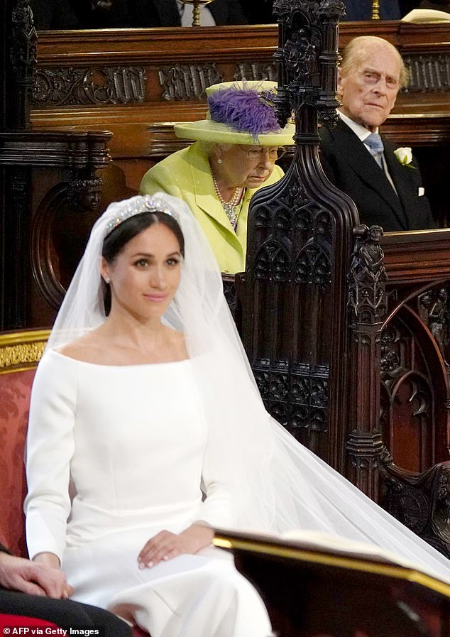 Prince Philip looks towards Meghan Markle during her wedding in 2018. Philip reportedly had   lukewarm first impression of Meghan