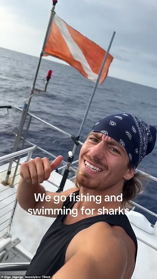 The man smiles into the camera and says he is going towards the tsunami to go fishing and swimming