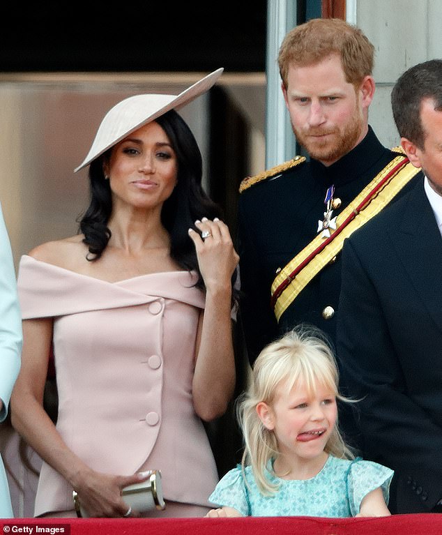 With the world watching Meghan's debut on the balcony of Buckingham Palace during Trooping alongside senior members of The Firm, it appeared Prince Harry may have been conscious of any criticism when he tried to explain the proceedings to his new bride