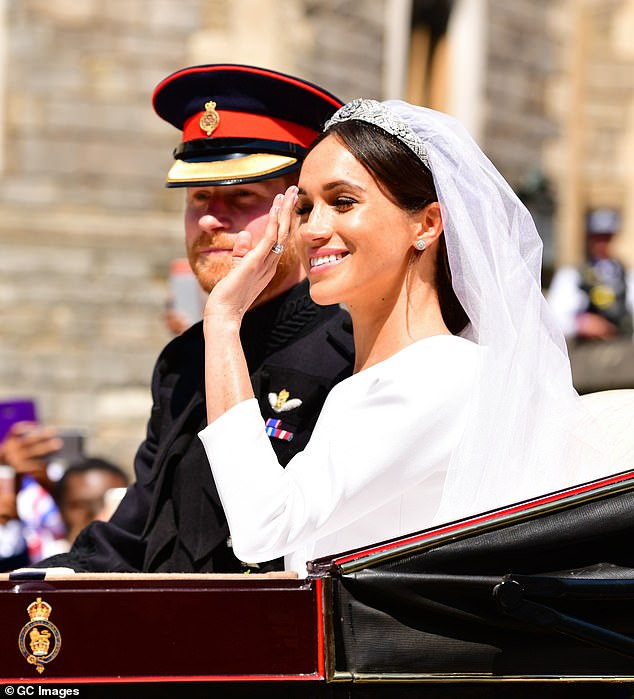 Harry and Meghan wave to onlookers on their wedding day. Despite his absence, Thomas still continued to cause 'chaos' for the bride and groom