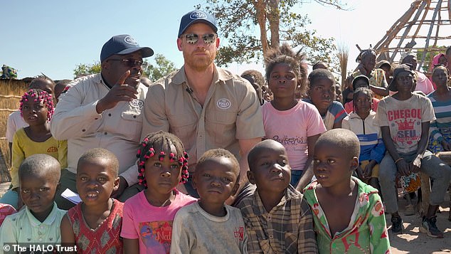 The Duke of Sussex with children in a remote village near Africa's largest remaining minefield as part of HALO's community outreach programme