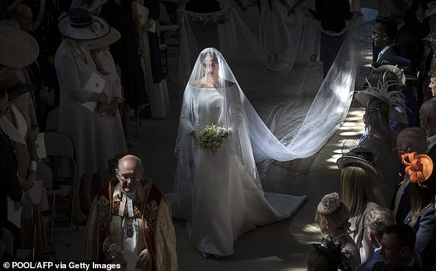 Meghan's 16ft-long veil was trimmed with lace depicting flora from each of the 53 Commonwealth countries