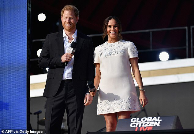 The Duchess of Sussex picked the white, embellished Valentino shift dress - decorated flower appliqués - for her birthday, with Meghan previously wearing knee-skimming frock in 2021. She last reached for the dress, which retails for around £4,000, when Meghan and Harry attended the Global Citizen Live charity concert in New York's Central Park in September 2021 (above)