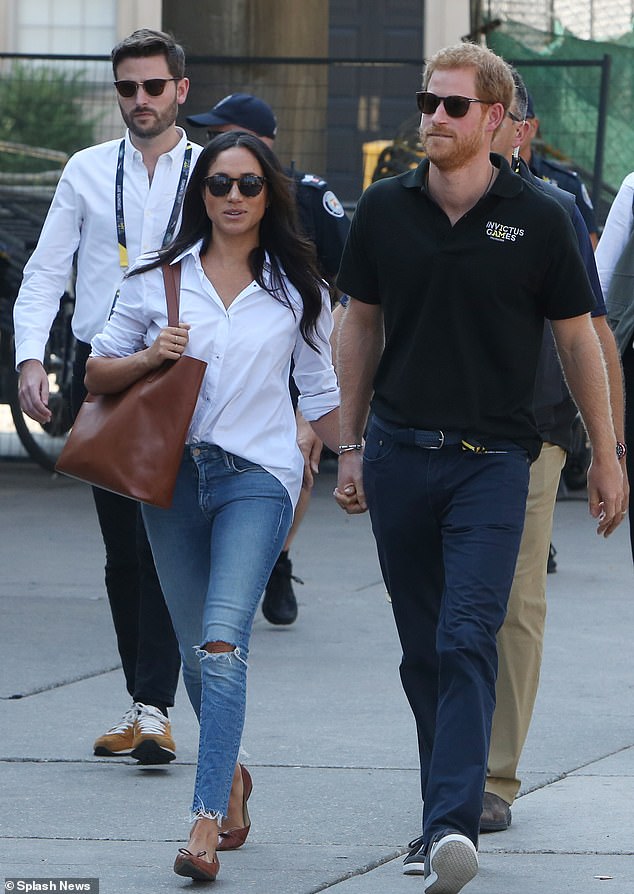 Harry and Meghan with Jason walking behind them. In the autumn of 2018 Harry and Meghan's working relationship with Jason was 'over' but he remained employed by them until March 2019