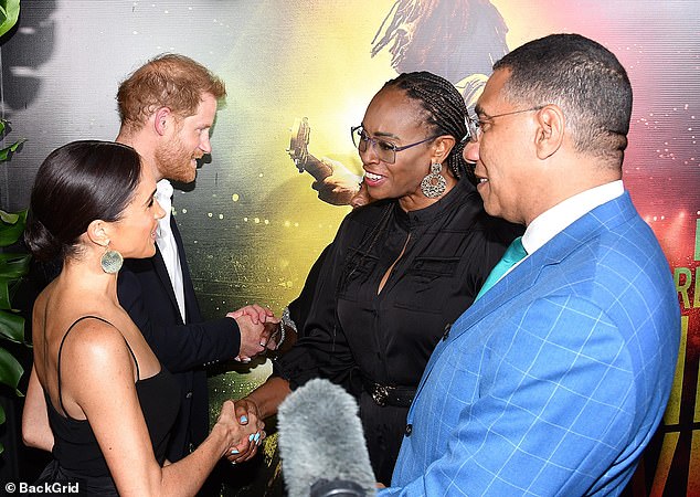 Meghan and Harry shake hands with the Jamaican premier and his wife at the event