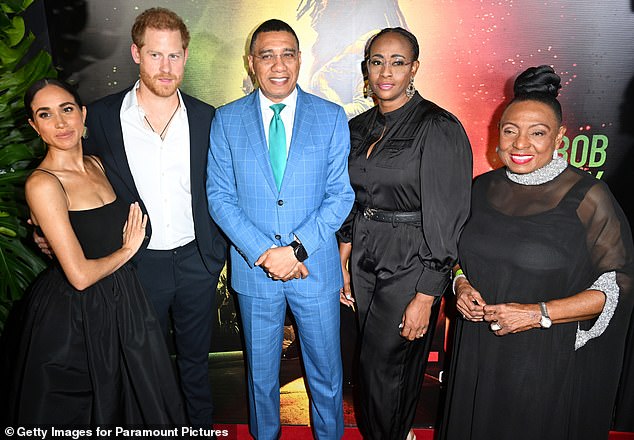 The pair's appearance at the biopic was controversial due to them posing with Mr Holness (centre) and his wife, Juliet (second right) at the premiere