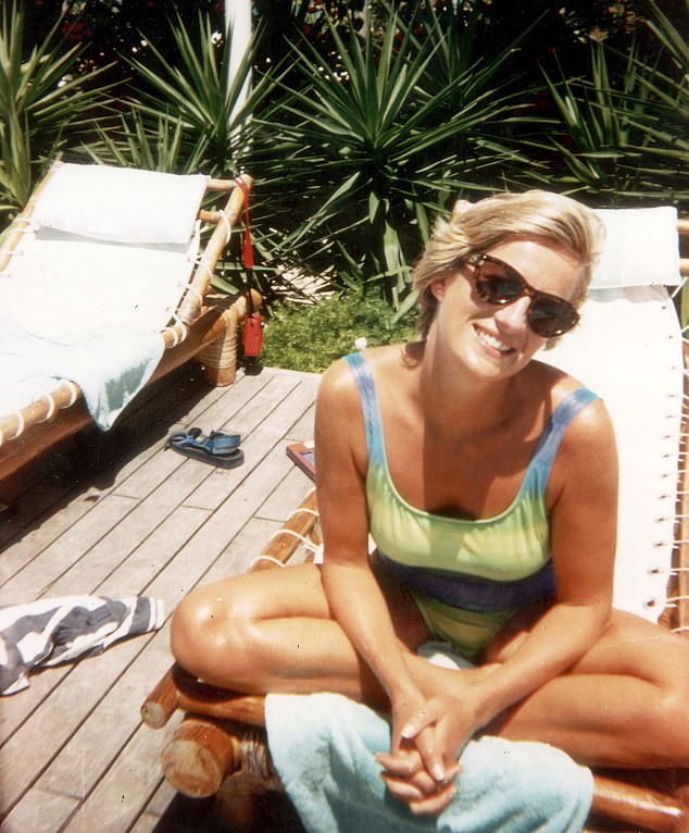 Princess Diana smiles while sunbathing on a lounger on the Caribbean island of Barbuda in 1996