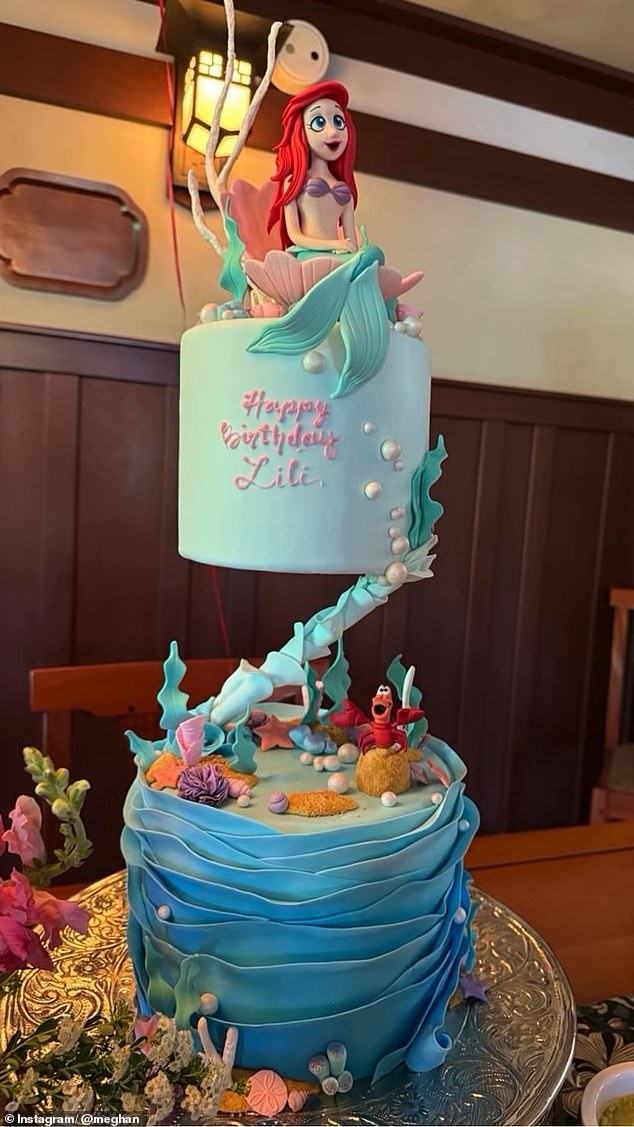 One snap showed Lilibet and Archie admiring a The Little Mermaid-themed cake (pictured), featuring the writing 'Happy Birthday Lili' to mark the Princess' fourth birthday, alongside two tiers of characters, including Ariel and the crab, Sebastian