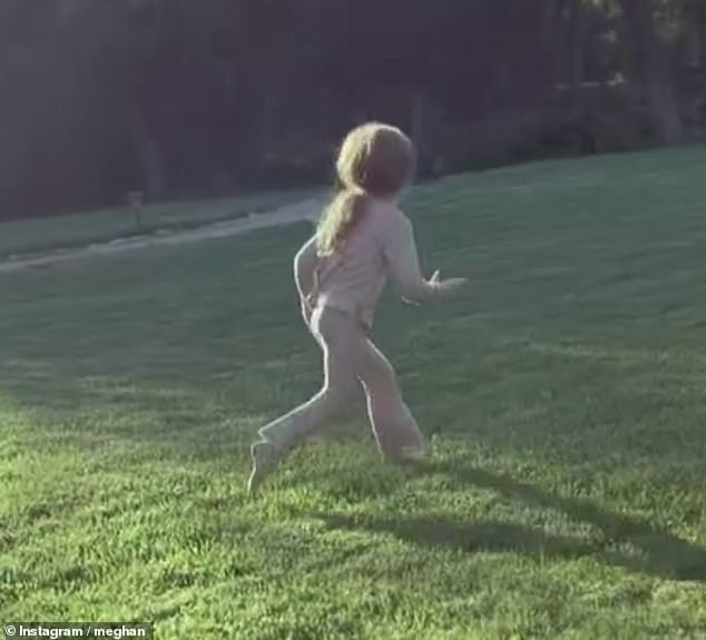 Meghan also posted an adorable video clip of Lilibet running around on the grass