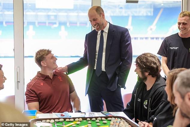 Rugby player Jac Morgan and Prince William participate in arts activities during his visit to new a mental health hub run by the Jac Lewis Foundation