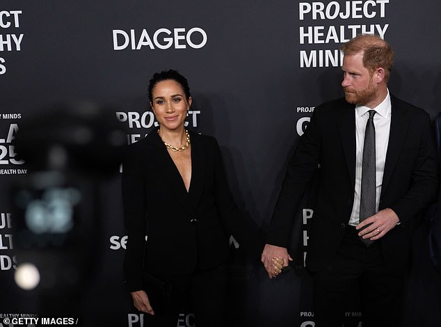 Prince Harry shuffles away as Meghan pauses for one more photo in New York last night