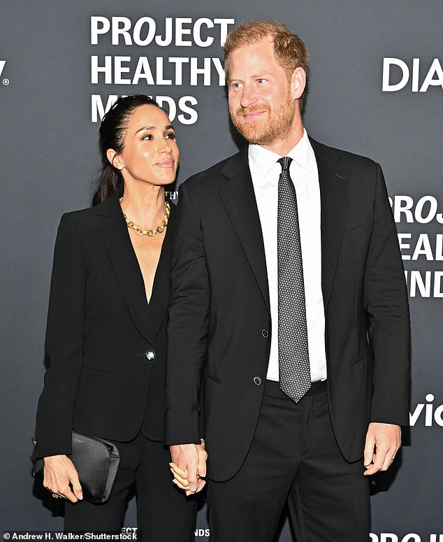 Meghan, 44, turned heads in a fitted black velvet pantsuit and chunky gold necklace