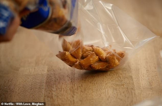 In one scene, Meghan teared open a pre-packaged bag of supermarket pretzels, transferring them into her own plastic bag