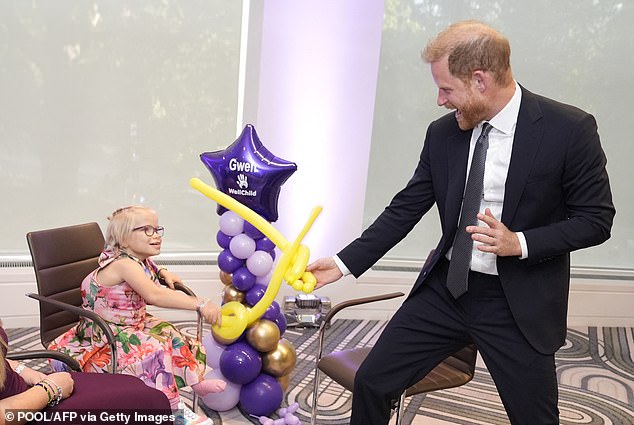 The stalker was allowed to enter a 'secure zone' at a hotel in central London where the Duke of Sussex was present for the WellChild Awards. Pictured: Prince Harry (right) playfighting with nine-year-old Gwen Foster (left) using swords made from modelling balloons at the WellChild Awards last month