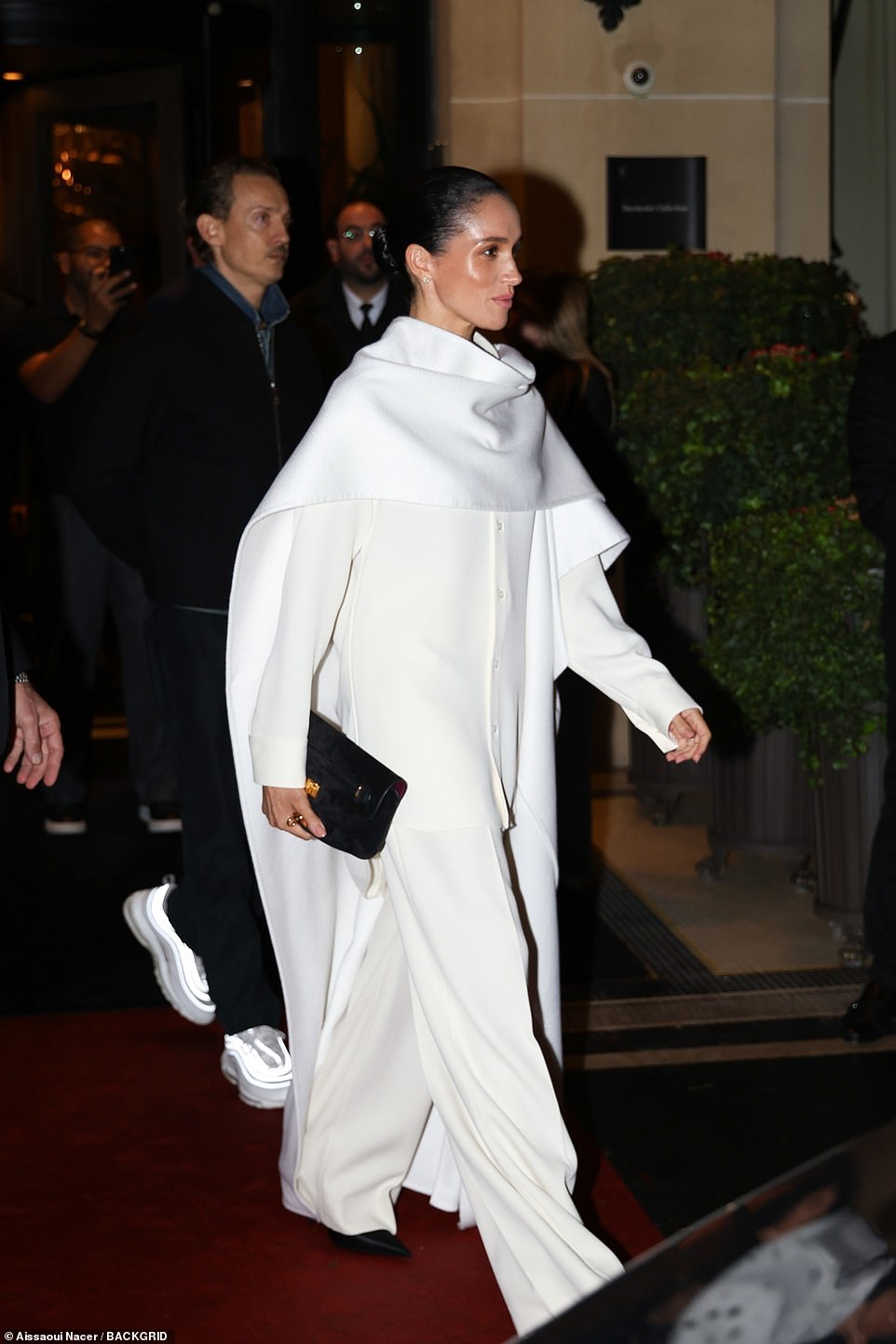 The creative added in the post's caption, 'Wow- what an overwhelming reaction you all have had to this look of Meghan's last Saturday night for the Balenciaga show! 'It's been a whirlwind but I wanted to just quickly give a few insights behind the skincare/makeup approach we took. Hope this helps for anyone who wants to recreate at home! Sending love.' Meghan was seen at the show for luxury fashion line Balenciaga last Saturday, mingling with fellow guests including Vogue's global editorial director Anna Wintour, actress Anne Hathaway and film director Baz Luhrmann, with whom she exchanged a kiss .