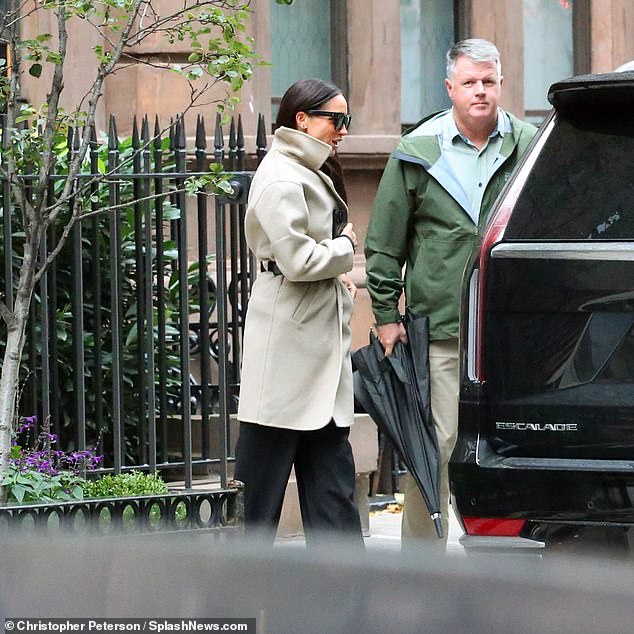 Meghan was swept away in a waiting Cadillac Escalade SUV