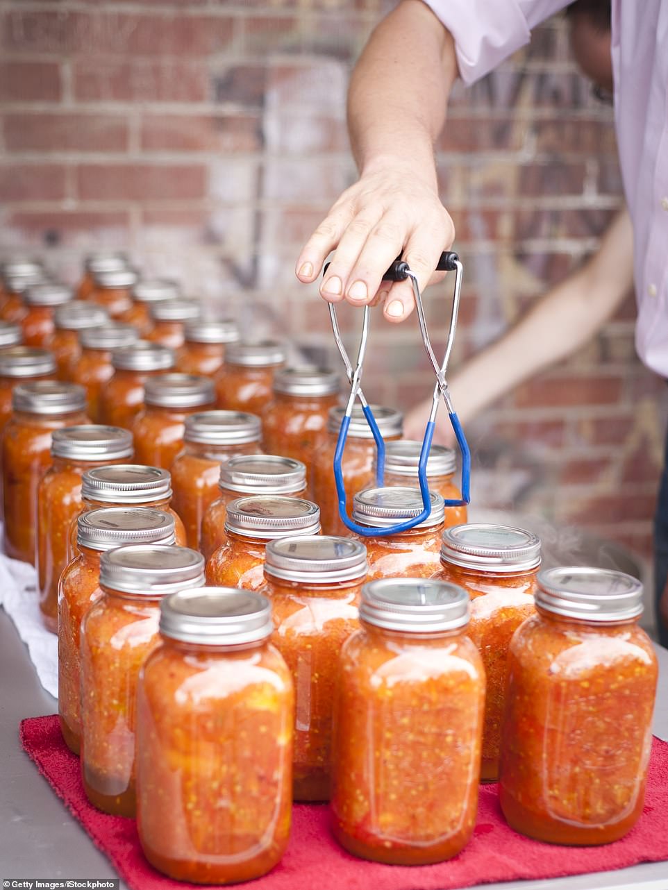 To accompany the new launch, Meghan shared new photographs of herself posing candidly in the kitchen of her Montecito mansion in California , using canning equipment to pull a jar of jam out of a large saucepan on the stove. The release and its accompanying pictures initially appeared to go relatively unnoticed in the wake of the former royal's disastrous Paris Fashion Week trip - where she was accused of 'giggling' after a model fell over and was filmed in a series of awkward interactions with A-listers.