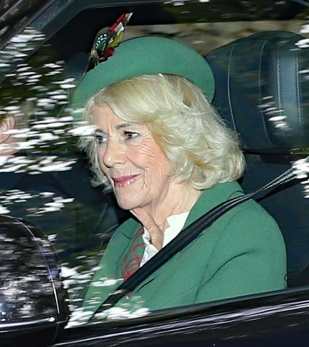 Offering a gentle smile during her journey, the Queen looked elegant in a green tartan ensemble with a matching pillbox hat with a feather adornment