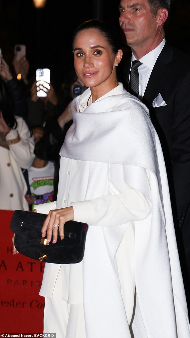 She paired it with black pointed-toe heels and simple accessories, giving off a vibe of effortless elegance, topped off with a sleek, slicked-back bun