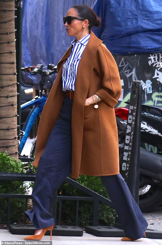 Meghan was also seen around town during her New York City visit sporting a long jacket by Max Mara, and a blue-and-white-striped button down by Ralph Lauren, one of her favorites