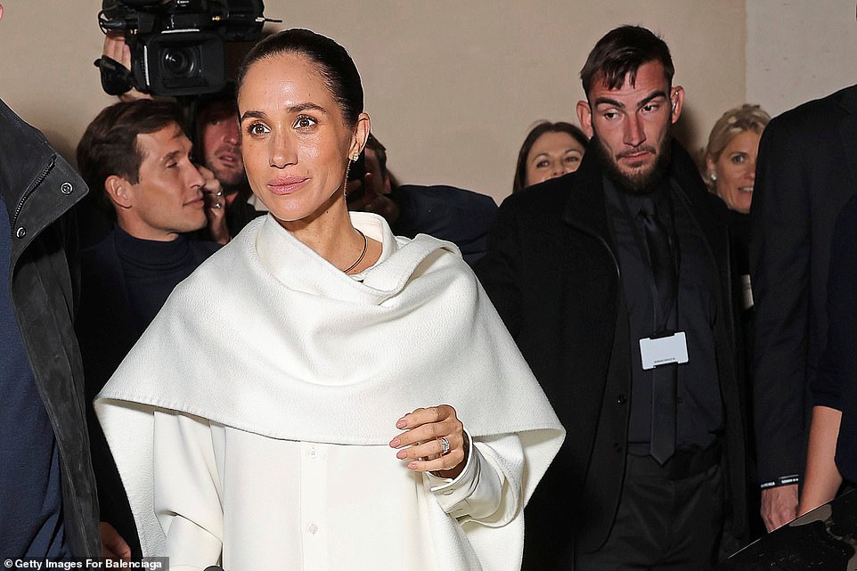 In a flurry of activity in October, Meghan popped up in Paris at the Balenciaga Spring-Summer 2026 show - where her daring white and black outfits made headlines around the world. Despite it being her first attempt to be taken seriously by the world of high fashion, Meghan found her whirlwind tour of the French capital beset by gaffes and awkward moments. She also shared an uncomfortable kiss with Balenciaga's designer Pierpaolo Piccioli - and ended up butting heads with him as they leaned in for an embrace. The Duchess then faced claims she may have made yet another front-row blunder, with video emerging of her appearing to laugh as a model took a tumble on the Balenciaga catwalk, next to her stony-faced friend. When her friend didn't seem amused, Meghan turned back around to watch the show with a more neutral expression, though a representative insisted she was not laughing at the model falling.
