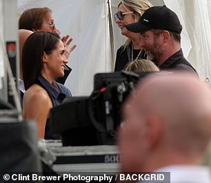 Meghan was seen holding a conversation with another attendee at the event over the weekend