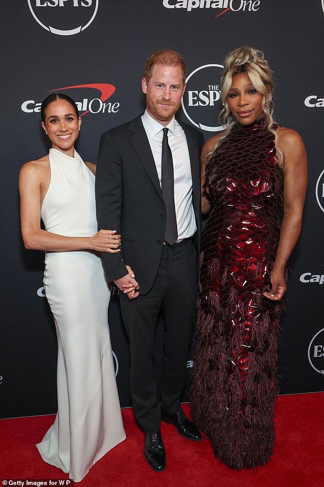 In photos with Harry, Judi commented that Meghan makes herself very integral to the poses thought, nestling in close and flattering Harry. Pictured: Meghan, Harry and Serena Williams at a Hollywood red carpet event in 2024