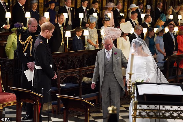 Prince Harry looks at his bride, Meghan, as she arrives accompanied by her father-in-law, King Charles, in St George's Chapel in 2018