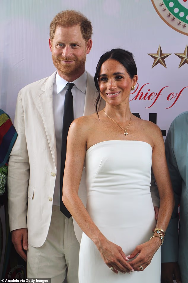 Despite their resignation, Harry and Meghan made a 'bold statement that they refuse to accept they are no longer working royals' with their quasi royal tour of Nigeria last year. They are seen here in matching white looks during a tour stop in Abuja