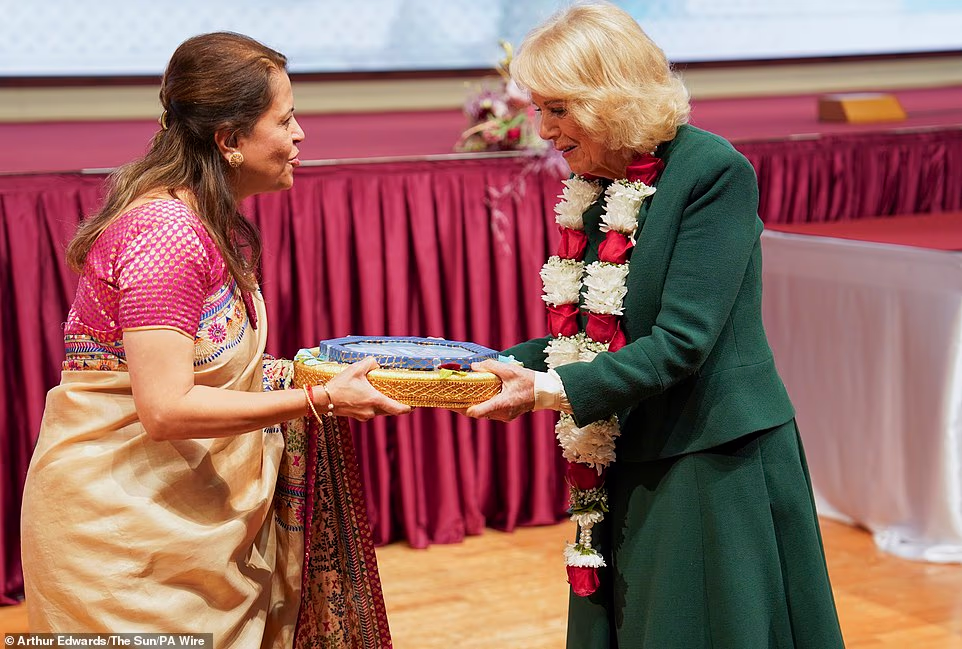 Viewing the model of the Parisian temple, the Queen said, 'It does look very impressive.' The congregation, wearing traditional Indian dress, stood and applauded as the King and Queen entered the main assembly hall. Children lined the central aisle waving BAPS flags. Men and women were seated either side of the central aisle. The King sat on the left hand side of the stage, in front of the male congregation, while the Queen sat on the right, in front of the women. School children performed Shanti Path, a Vedic prayer for world peace.