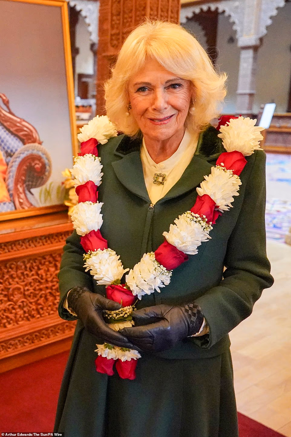 There was a video message from the spiritual leader Mahant Swami Maharaj, 92, from India, who thanked the King and Queen for their visit. He said, 'Your kindness and friendship have long been cherished by our community.' The head priest then presented the King with a special gift and the Queen with sweets, representing, 'the sweet enduring friendship between the crown and our community'. As the King and Queen walked back down the central aisle, the congregation gave a cheer. Dev Patel, 11, who visits the temple weekly with his family, found out the day before that he would be offering petals to the central shrine for Bhagwan Swaminarayan in front of the King.