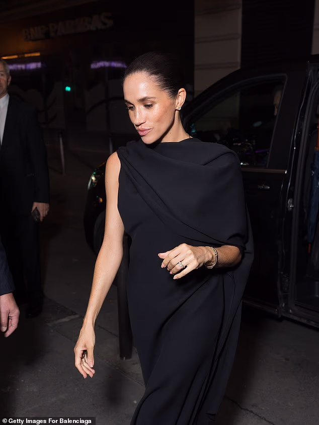 The duchess had an outfit change later into the night, stepping out in a black gown that featured one arm exposed