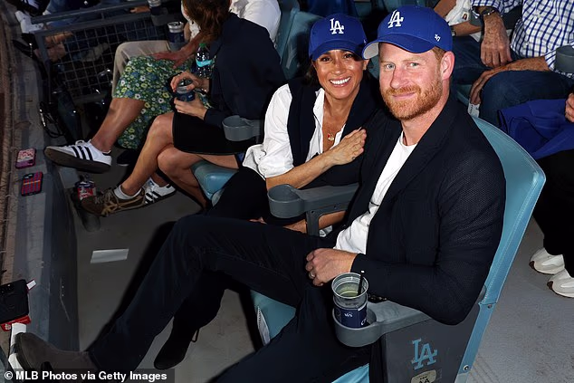 Readers called for the King to also take away Harry and Meghan's royal titles (Pictured: Harry and Meghan at a baseball game in LA on Tuesday)