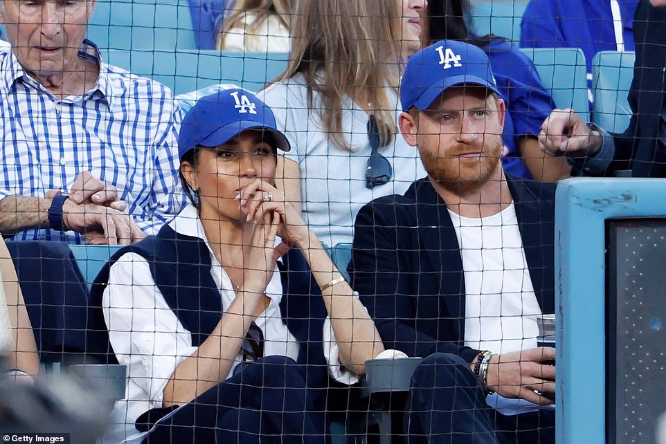 Prince Harry and Meghan Markle have left Dodgers fans far from impressed after being handed the best seats in the house for a front-row date night at Game 4 of the World Series. The superstar couple, now seemingly deeply ingrained in LA life, were decked out in Dodgers merch for the big game on Tuesday night, with Fox's TV cameras regularly zoomed in on them as they enjoyed the action. In a surprising decision quickly noticed by fans, Harry and Meghan were given front-row seats worth tens of thousands of dollars - while local legends Magic Johnson and Sandy Koufax were relegated to the second row.