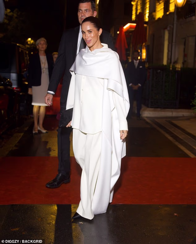 Meghan paired her outfit with black pointed-toe heels and simple accessories, giving off a vibe of effortless elegance, topped off with a sleek, slicked-back bun