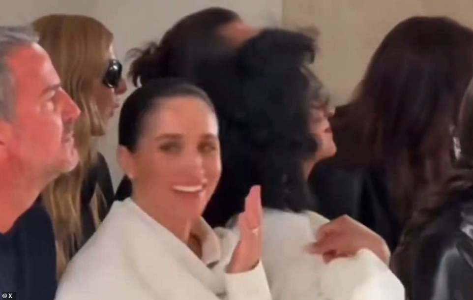 Meghan Markle is facing claims she may have made yet another front row blunder at Paris Fashion Week - with new video emerging of her appearing to laugh as a model took a tumble on the Balenciaga catwalk, next to her stony-faced friend.