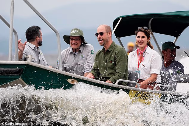Prince William, Prince of Wales (centre) rides in a boat during a tour of the Guapimirim mangrove area in Guanabara Bay