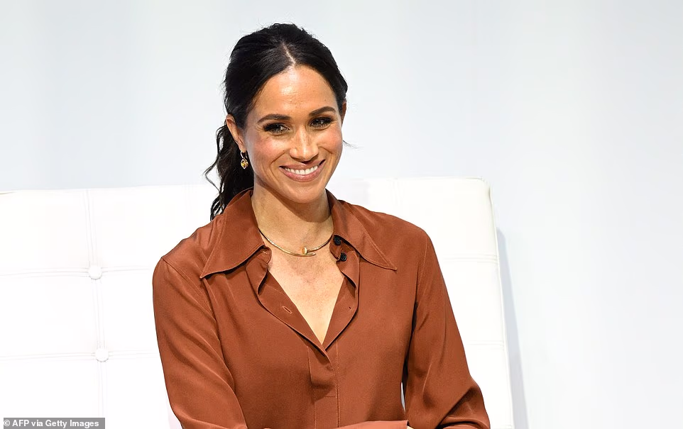 'Meghan keeps her eyes lowered, which has gentle echoes of Adele's cut-off with her bag over her face, the implication being similar, as in an 'I am too big a star to openly court the cameras or adopt poses like the reality girls are probably doing' look. 'A cut-off ritual like the lowered and hidden eyes suggests a coy lack of need to perform for the cameras, and it implies an assumption of rabid press interest rather than a courting of it. 'But Meghan also performs a smile of utter delight here. Her cheeks are rounded, and her lips are hiked up high at the corners to create a symmetric shape. 'A smile like this will be an acknowledgement to the fans and the cameras but without any posing effort or showboating.'