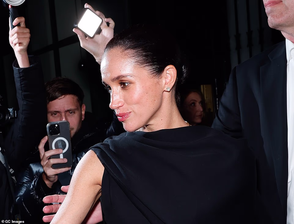 Meghan admits her parenting style is 'very different' to her mother Doria's - calling Ms Ragland a 'free spirit' - and that Archie and Lilibet sit on her lap during business meetings because her office is next to the kitchen of their Montecito mansion. She said: 'I hope they see the value of being brave. They saw it when the jam was just a pot on the stove, bubbling. When you're young, I think you are a little bit more fearless. As we get older, we lose some of that.' She added that she has applied this to her work: ' That's translated into every part of our life. Even in business, I want us to play and have fun and explore and be creative.' The Duchess of Sussex , 44, appeared on the front of the magazine's December 2025/January 2026 edition, which was labeled as the art issue. She appeared to be wearing no makeup in the photo, as she had her hair tied back, showing off a pair of dangling diamond earrings he brought back from Ukraine last month. In another photo for the magazine, Meghan posed in a sleeveless red dress with a dramatic cape draping over one shoulder.