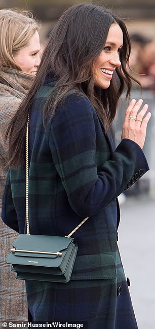 Meghan completed her winter outfit with a cross-body bag from Edingburgh-based brand Strathberry during her visit to the city in 2018