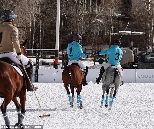 The Duke of Sussex is seen chatting with his teammate during the match