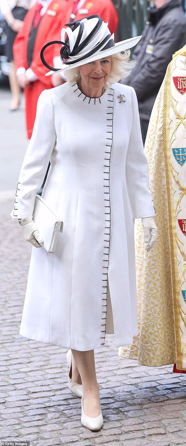 Black blanket stitching added a graphic edge to Queen Camilla's otherwise classic coat by Anna Valentine, giving the look a contemporary feel