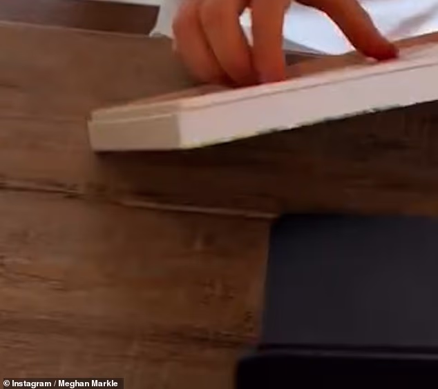 To contrast the all-white and cream furnishings, the prince opted for a dark brown, wooden desk - which stands out in the otherwise lightened space