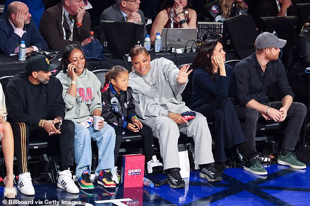 Queen Latifah and her partner, Eboni Nichols (second left), soaked up the action