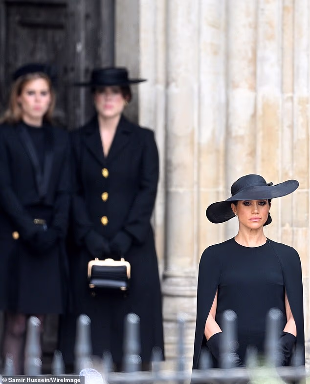 However, their friendship will likely be tested in the wake of Andrew's unprecedented arrest, as a royal expert suggested Meghan will want to 'distance' herself from the scandal surrounding the former prince's ties to paedophile Epstein. Pictured: The Duchess of Sussex standing in front of Princesses Beatrice and Eugenie during Queen Elizabeth's funeral in September 2022